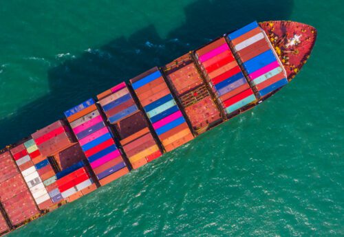 Container ship going to deep sea port, Business logistic import export shipping and transportation by container ship, Aerial view.