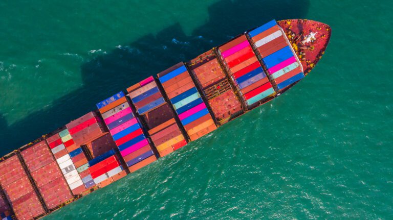Container ship going to deep sea port, Business logistic import export shipping and transportation by container ship, Aerial view.