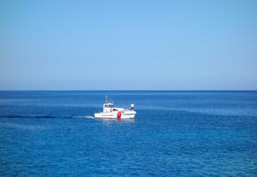 PIANOSA, ITALY - CIRCA JUNE 2020: Guardia Costiera (translation Coast Guard) boat in front of the island of Pianosa