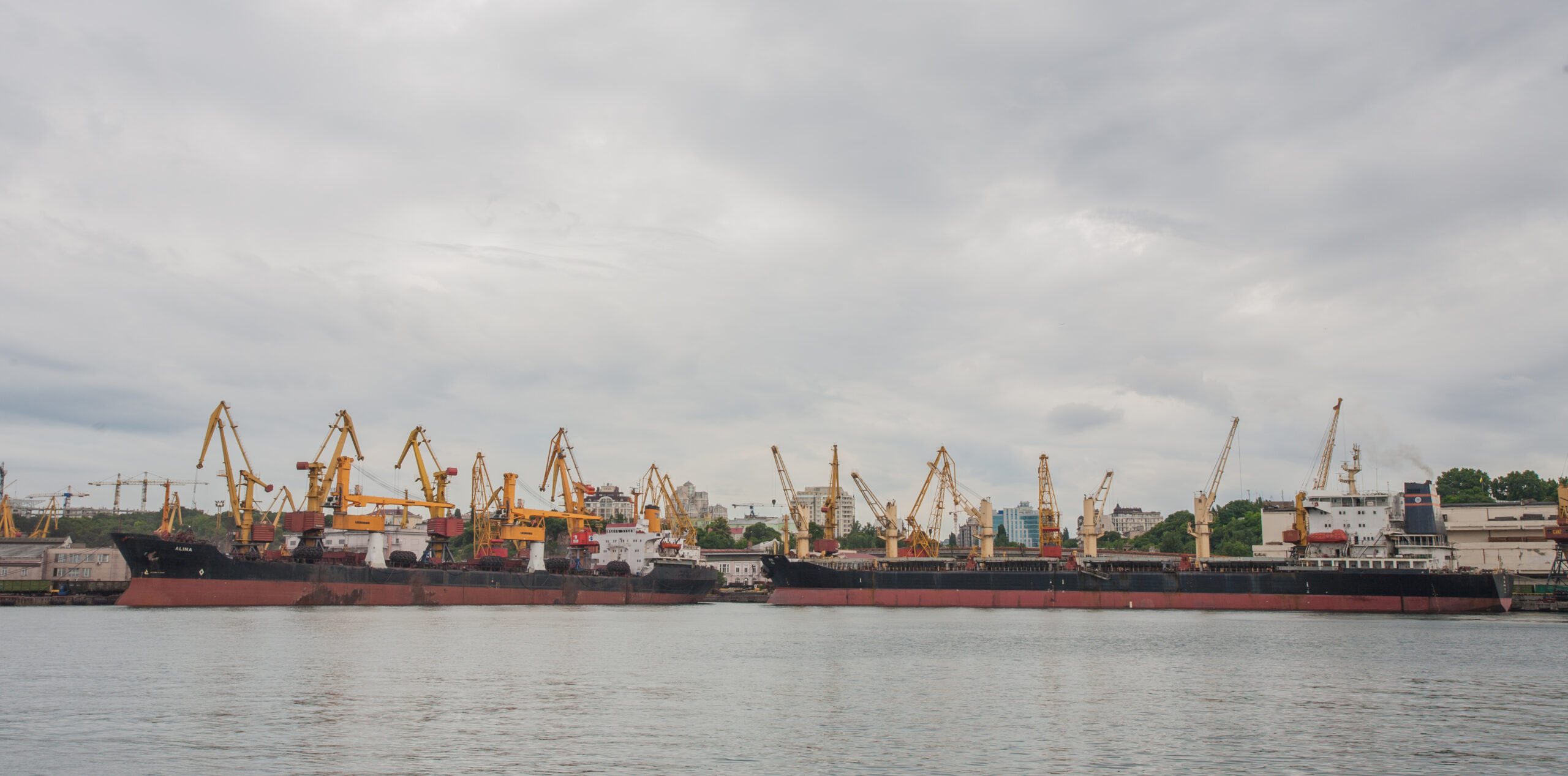 Lifting cargo cranes, ships and grain dryer in Sea Port of Odessa, Black Sea, Ukraine.