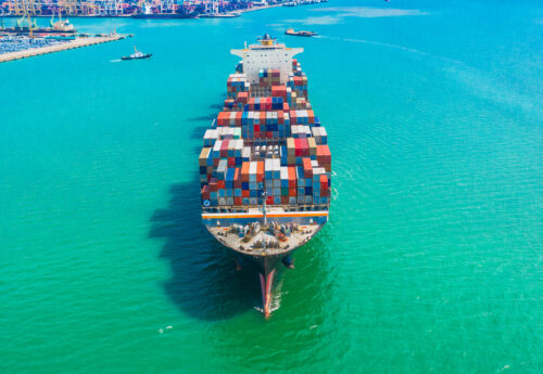 Container ship arriving in port, logistic business import export shipping and transportation.