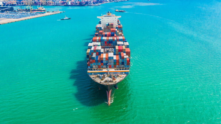 Container ship arriving in port, logistic business import export shipping and transportation.