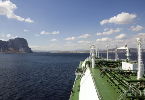 LNG carrier ship designed for transporting natural gas anchored off port.