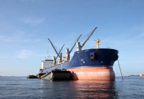 Supramax bulker with barges alongside