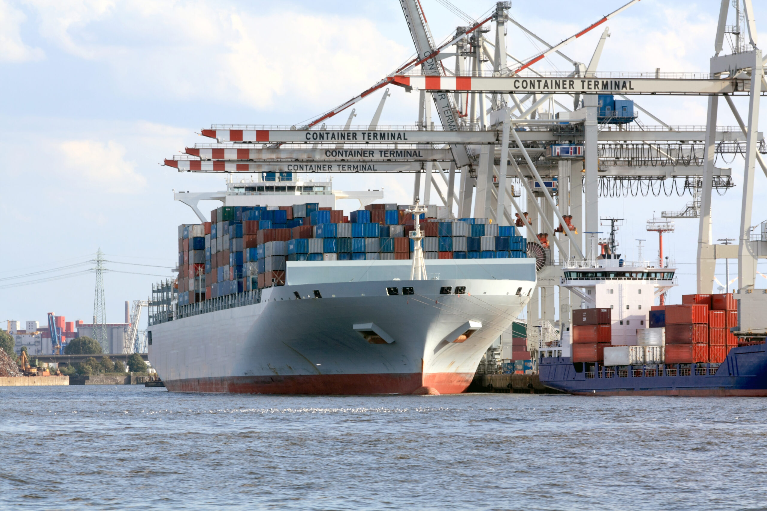 Large cargo container ship loading freight in port of Hamburg