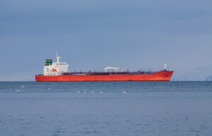 Red product tanker approaching port in Helguvik, Iceland.