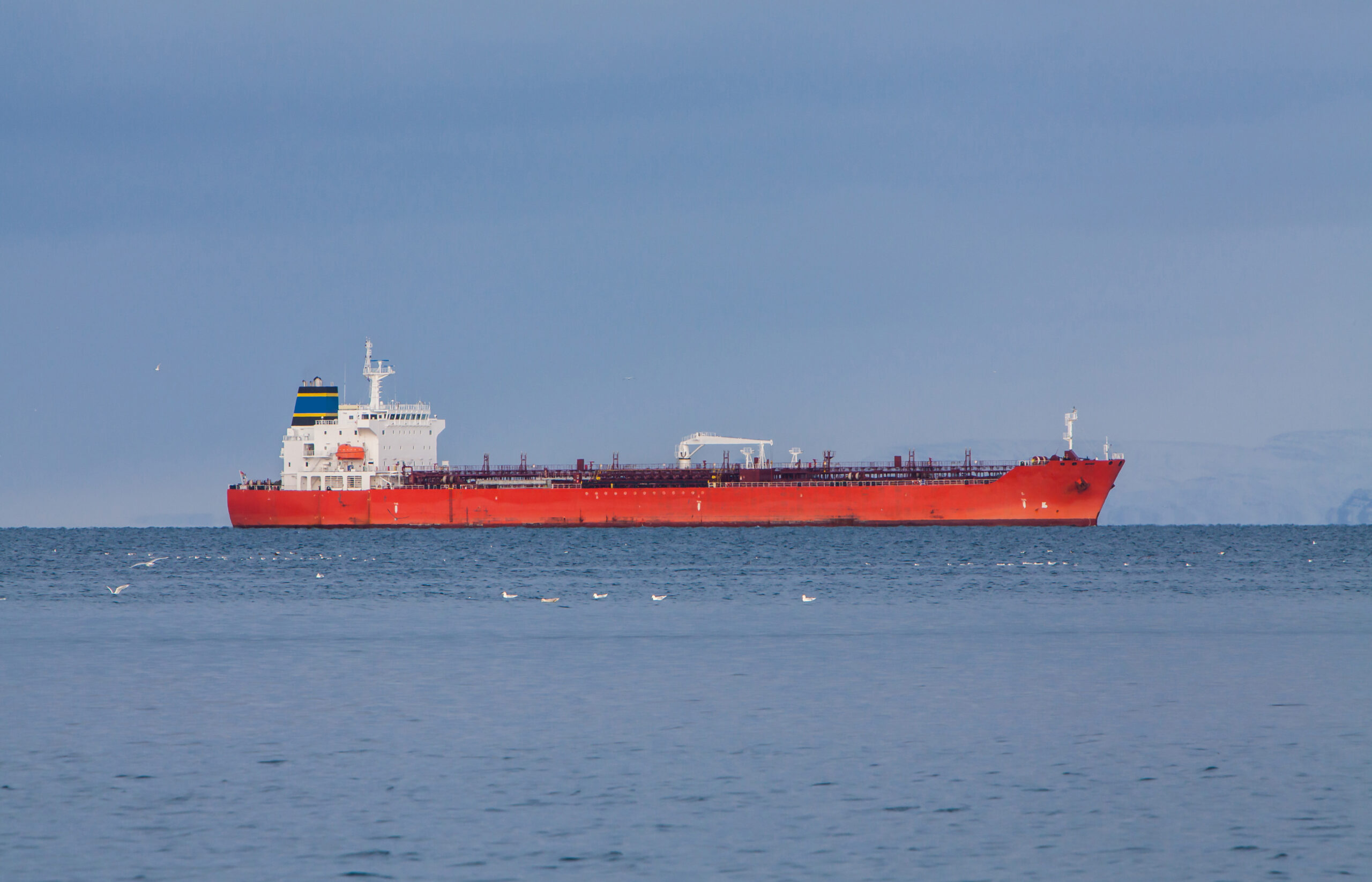 Red product tanker approaching port in Helguvik, Iceland.