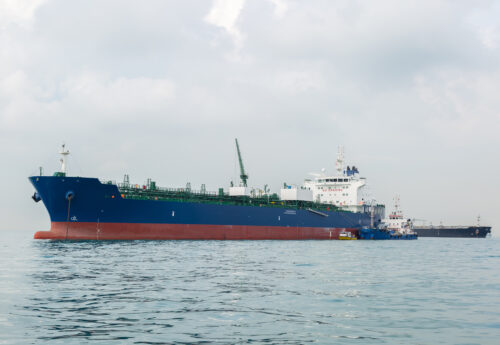 Blue tanker is bunkering by small bunker tanker in the open sea