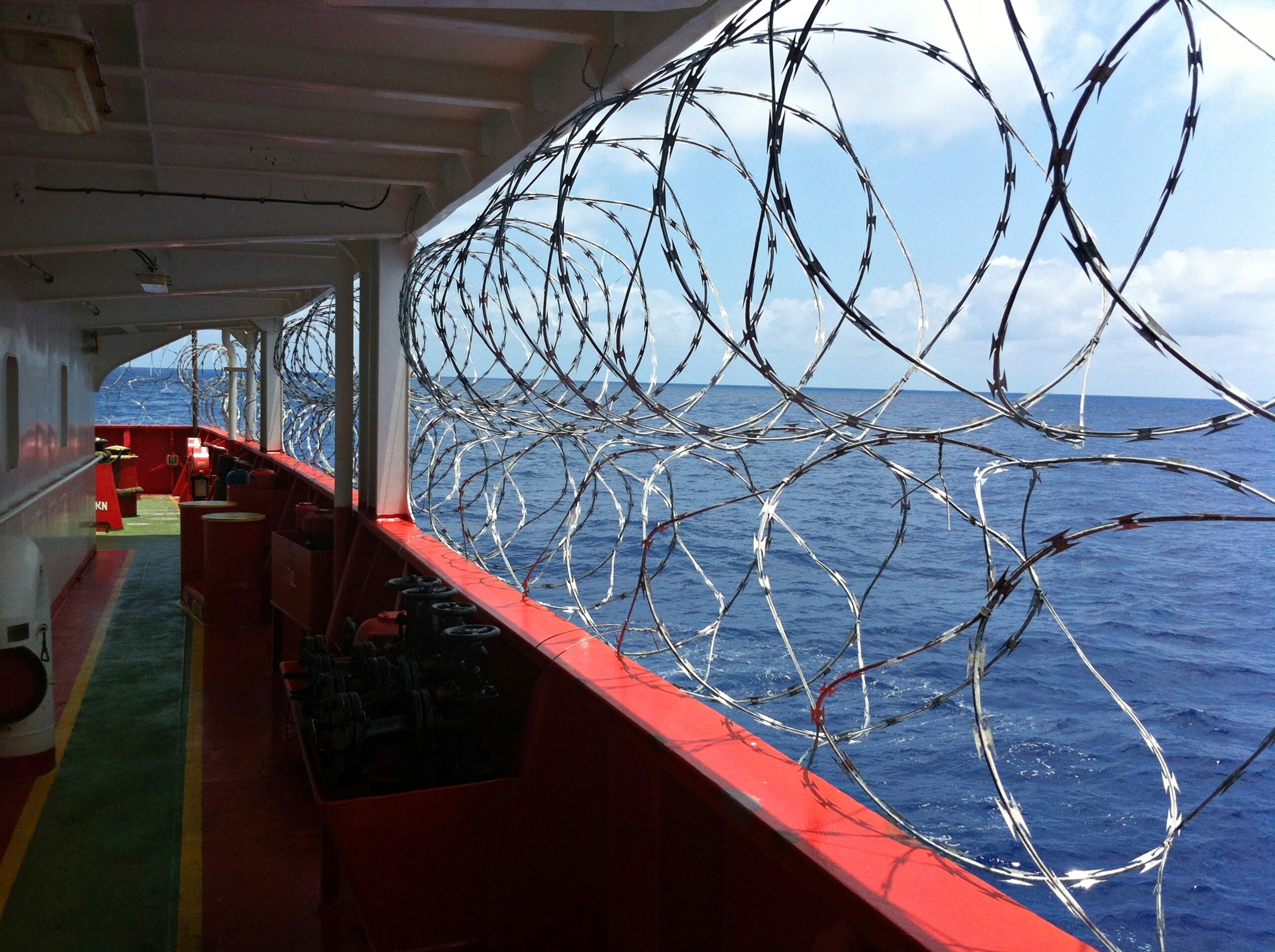Barbed wire is twisted on board the tanker to protect against pirate attacks when sailing in dangerous areas of the seas