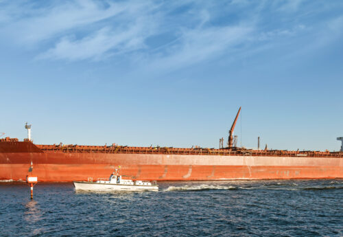 Big red oil tanker passes through the Suez Canal