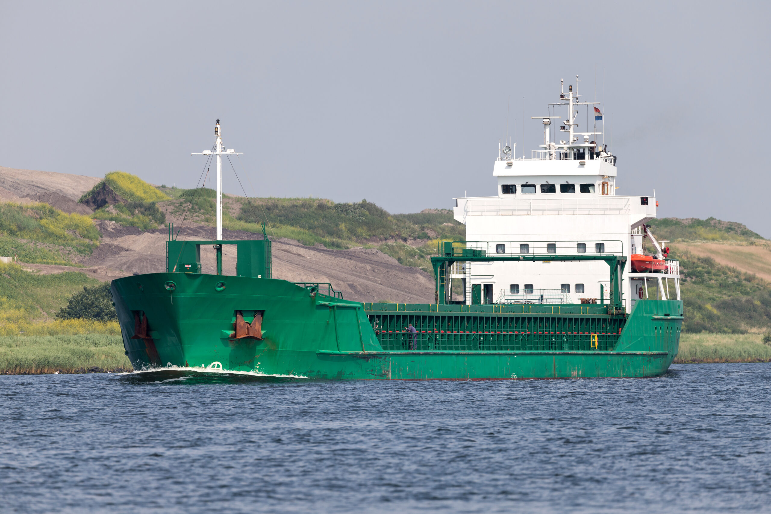 General cargo vessel shipping on canal