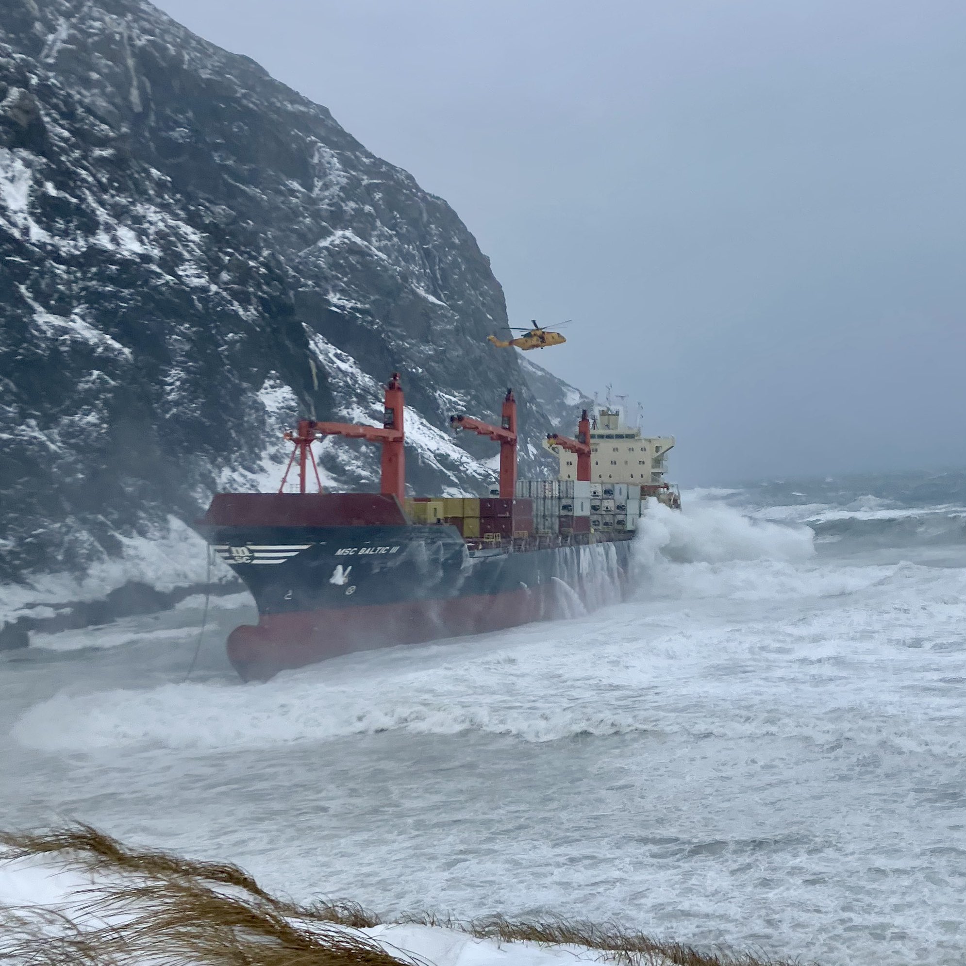 Crew rescued as cargo ship runs aground in rough seas