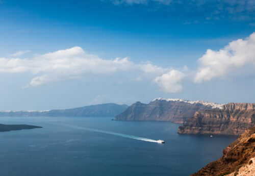 Panoramic view over Santorini Island with a ferry