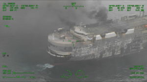 Dramatic images show the blaze-Zodiac vehicle carrier as salvage tug arrives