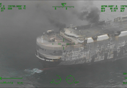 Dramatic images show the blaze-Zodiac vehicle carrier as salvage tug arrives