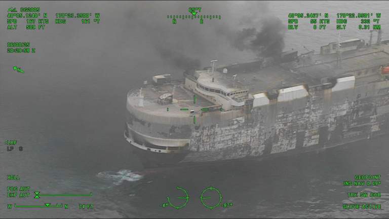 Dramatic images show the blaze-Zodiac vehicle carrier as salvage tug arrives