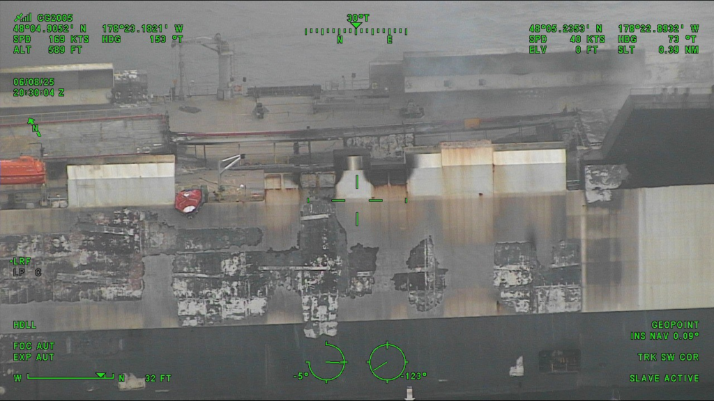 Dramatic images show the blaze-Zodiac vehicle carrier as salvage tug arrives